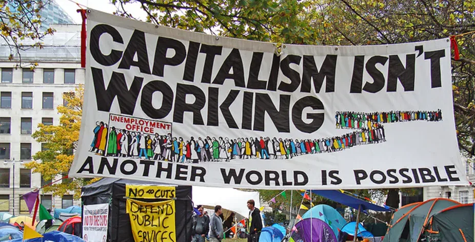 banner met “capitalism isn’t working”